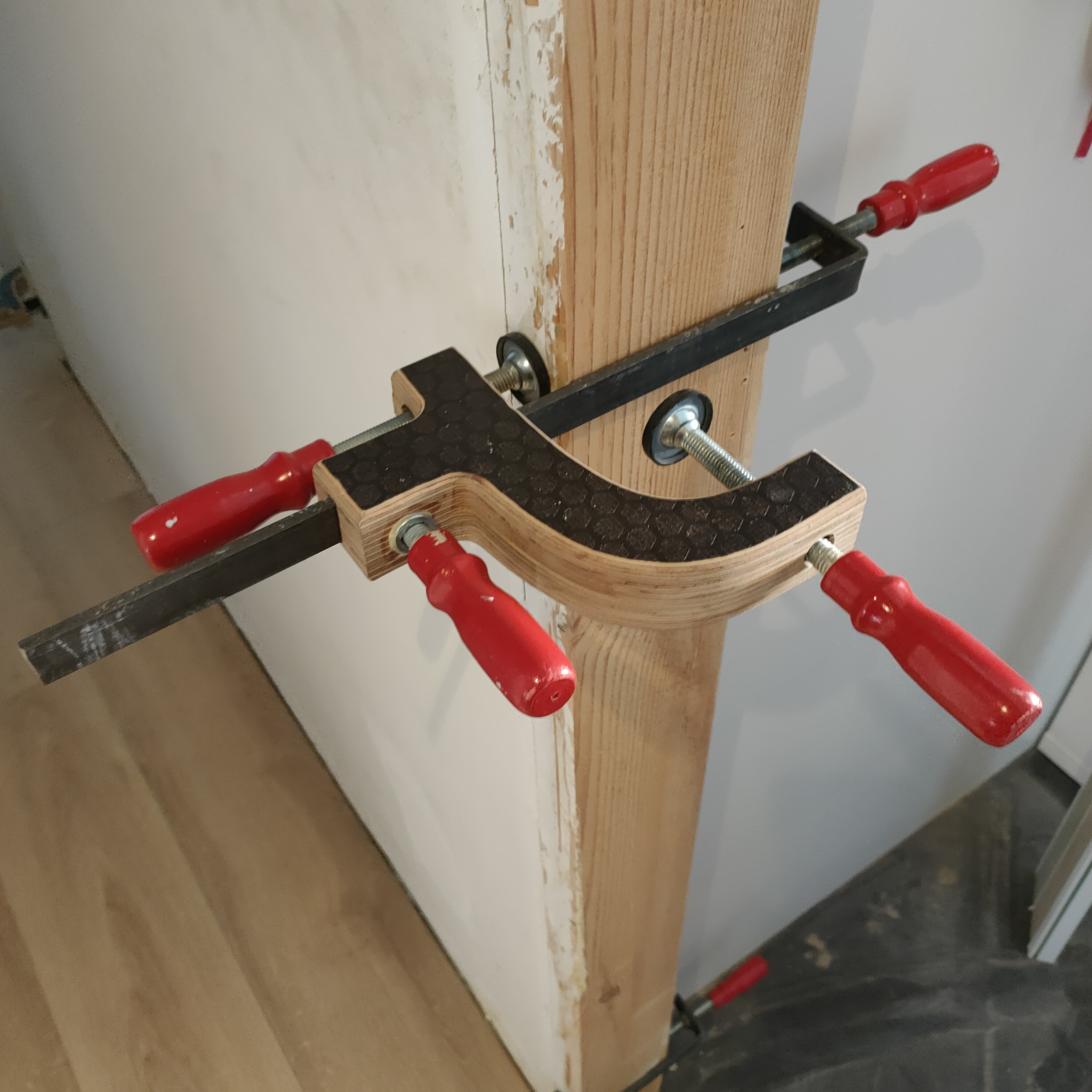 Detalle de Catblock sujetando un travesaño de madera durante el montaje de una puerta